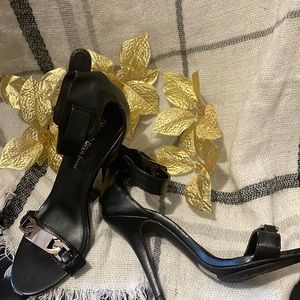 Size 6 1/2 brand while divas black with gold chains in the front